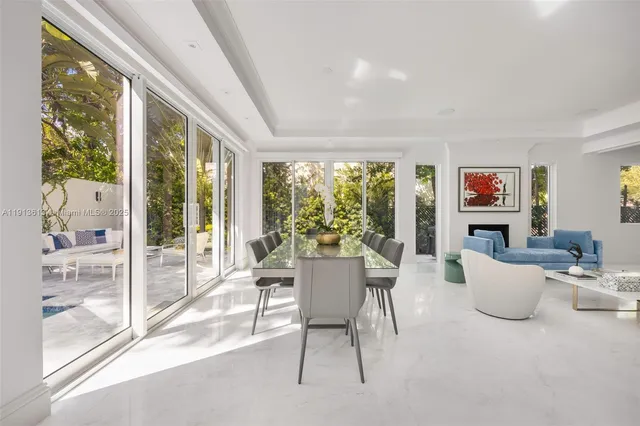 a view of a dining room with furniture large windows and backyard