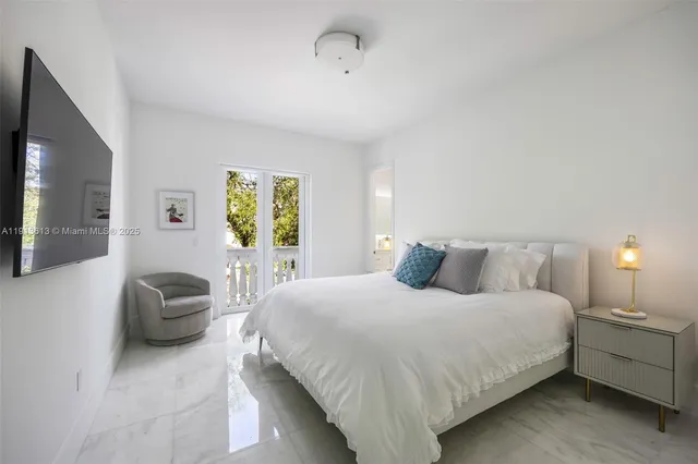 a bedroom with a bed and a couch