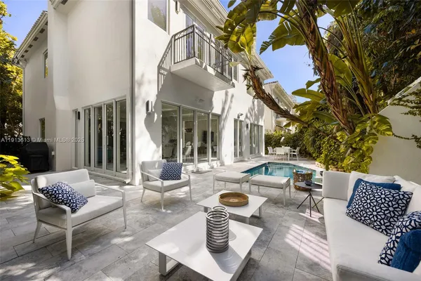 a view of a patio with couches table and chairs and potted plants
