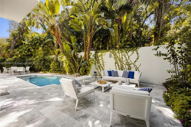 a backyard of a house with table and chairs