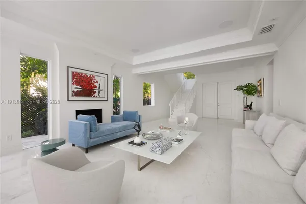 a living room with furniture a fireplace and a window