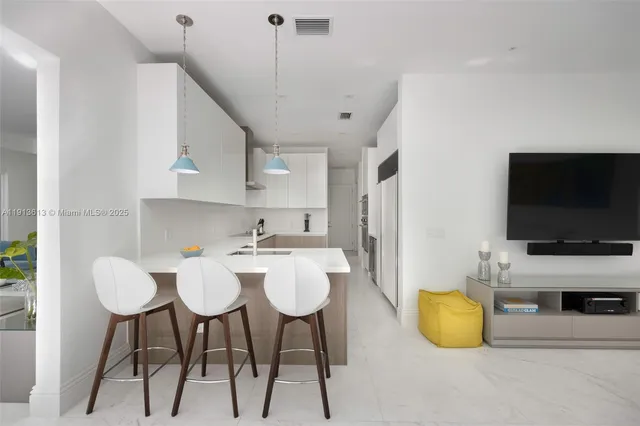a kitchen with a sink stainless steel appliances and white cabinets