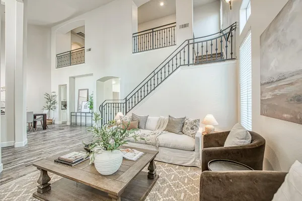 a living room with furniture and wooden floor