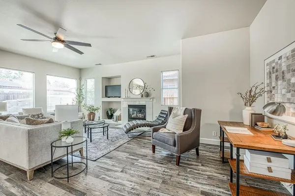 a living room with furniture a fireplace and a flat screen tv