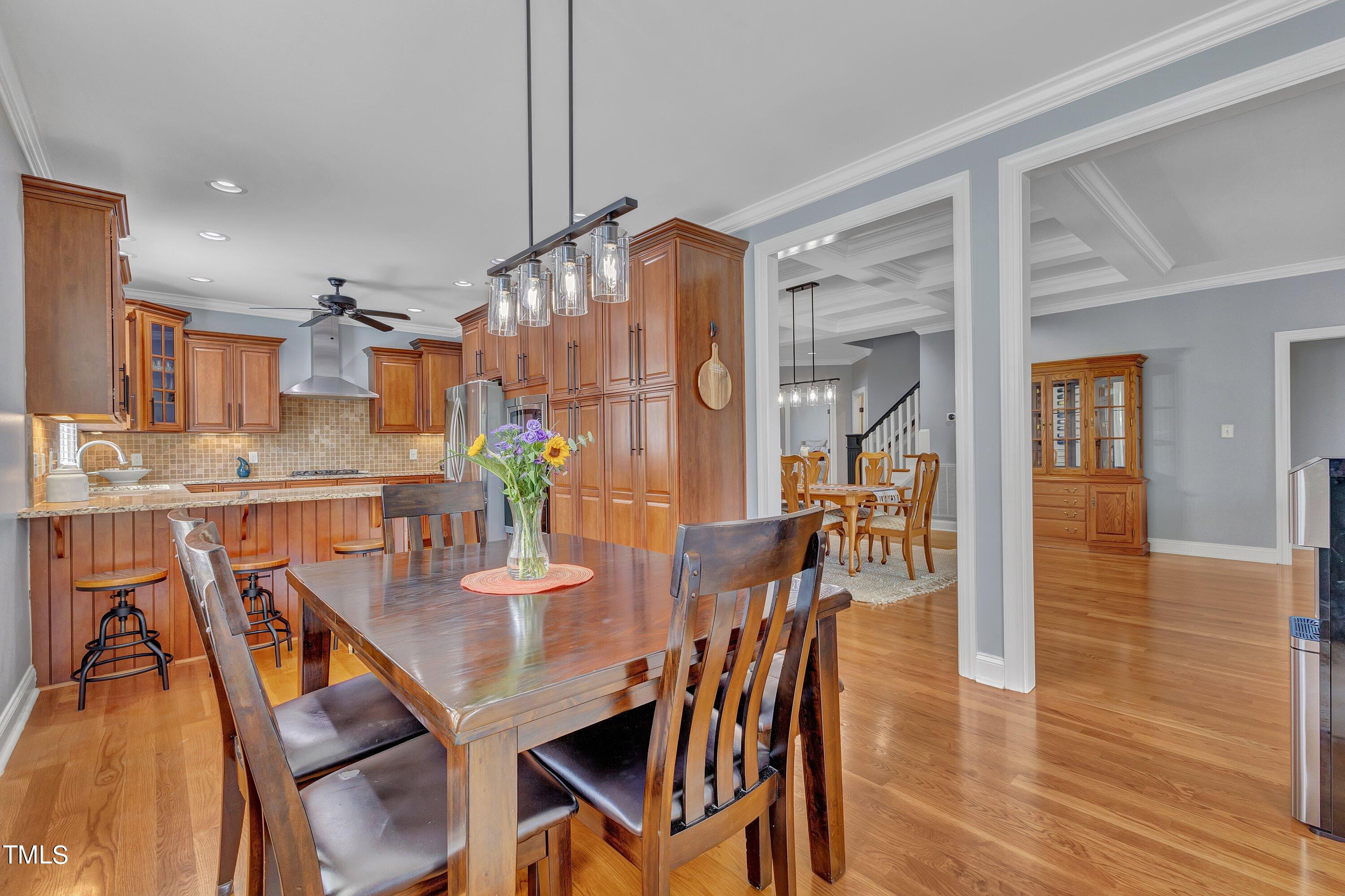 1741 Dunn Maple Drive Wake Forest, NC 27587 - Photo 13 of 63 a view of a dining room with furniture and wooden floor