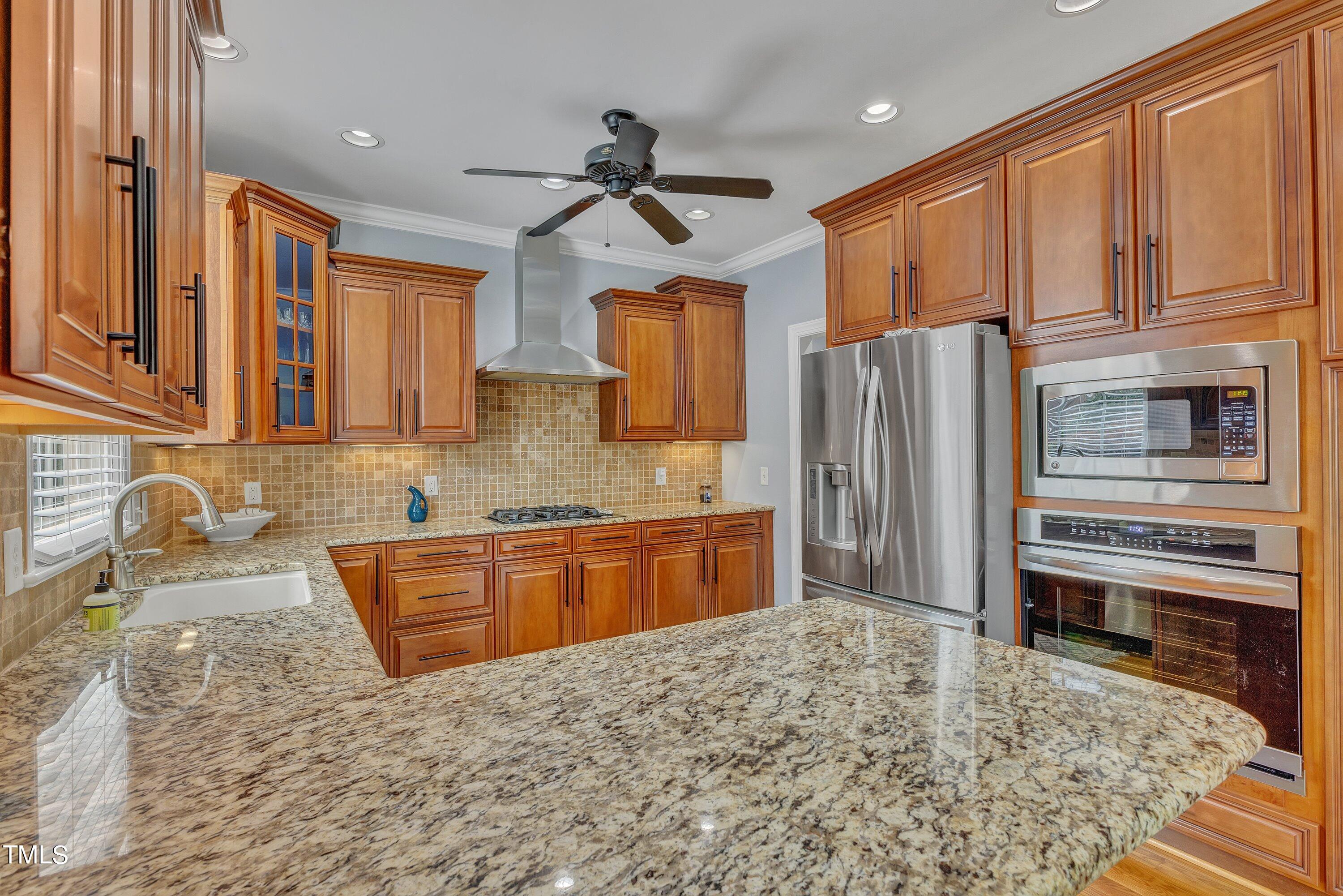 1741 Dunn Maple Drive Wake Forest, NC 27587 - Photo 15 of 63 a kitchen with stainless steel appliances granite countertop a refrigerator stove and sink