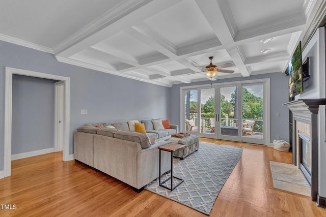 a living room with fireplace furniture and a large window