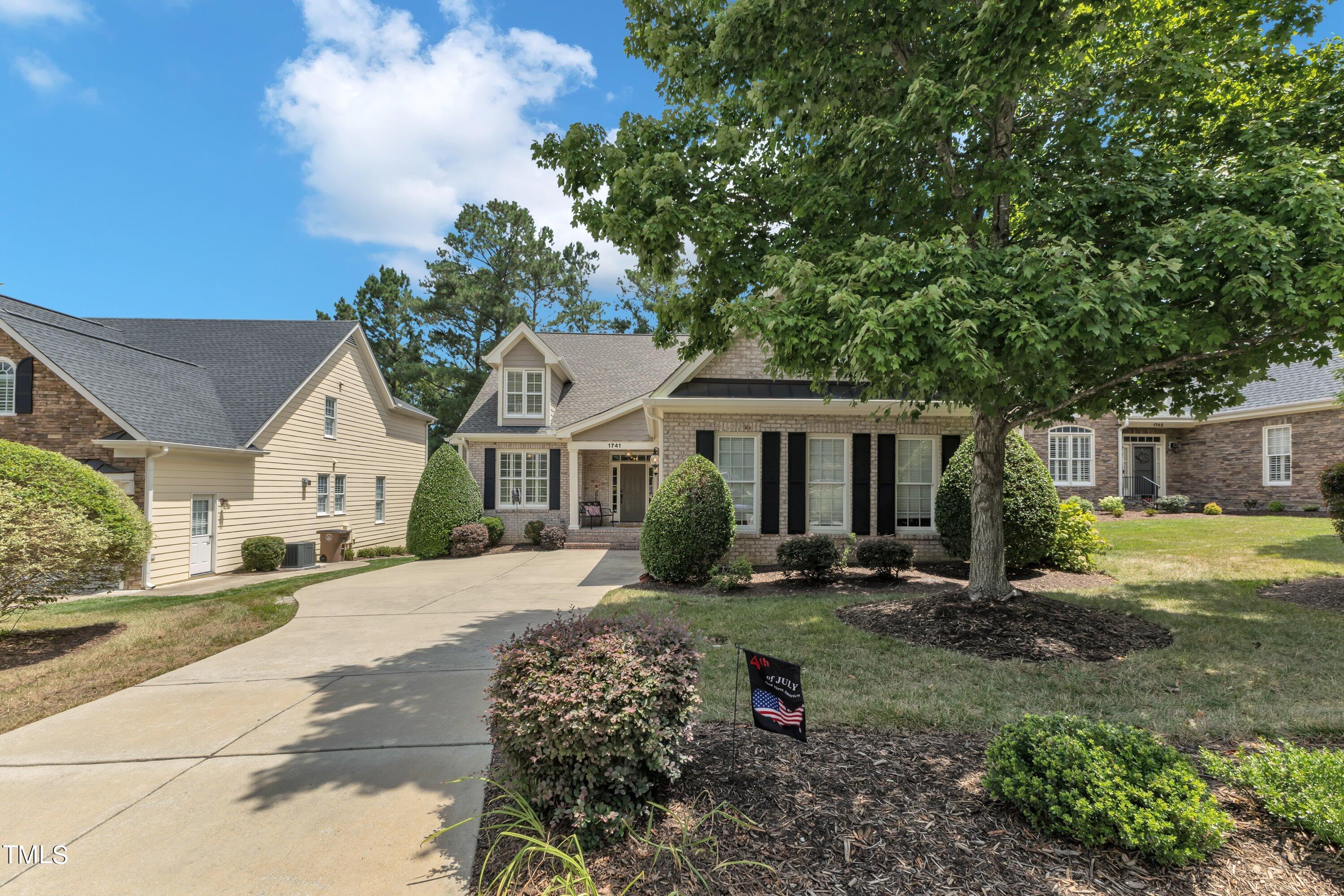 1741 Dunn Maple Drive Wake Forest, NC 27587 - Photo 2 of 63 a front view of a house with garden