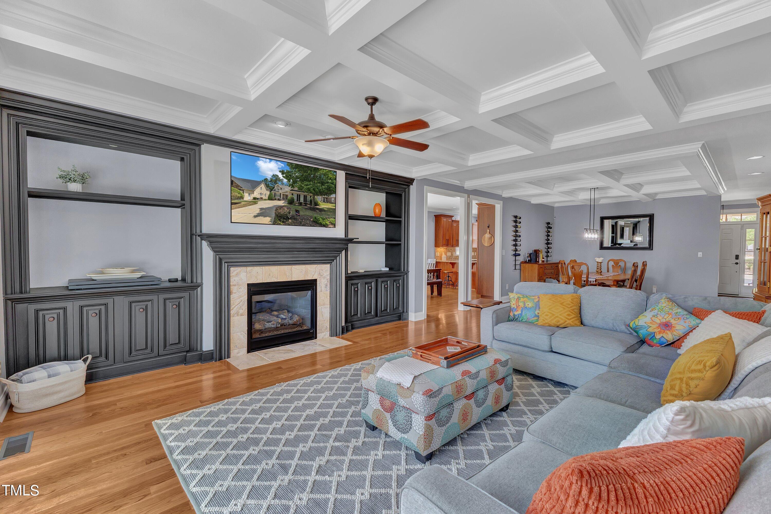 1741 Dunn Maple Drive Wake Forest, NC 27587 - Photo 22 of 63 a living room with furniture a fireplace and a flat screen tv