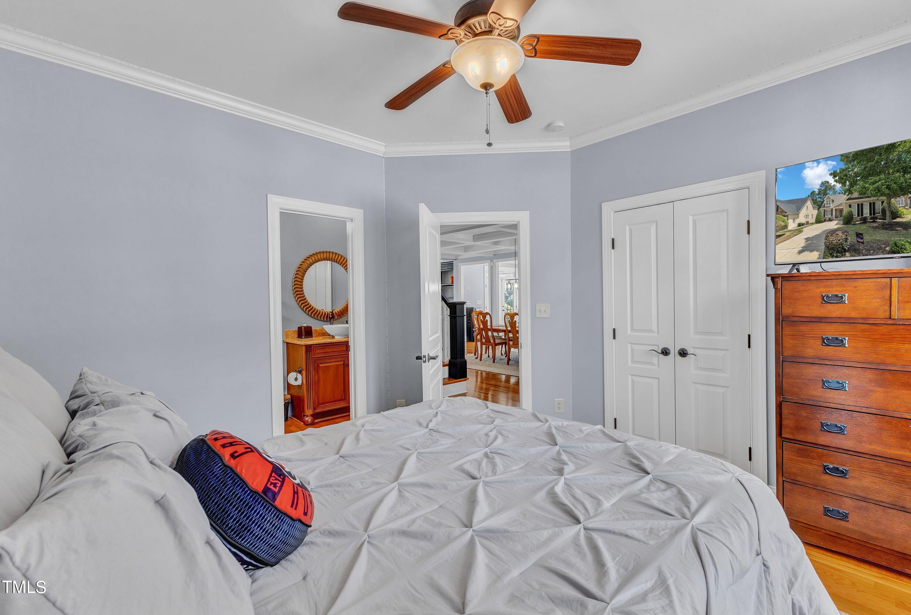 1741 Dunn Maple Drive Wake Forest, NC 27587 - Photo 24 of 63 a bedroom with a bed and a chandelier