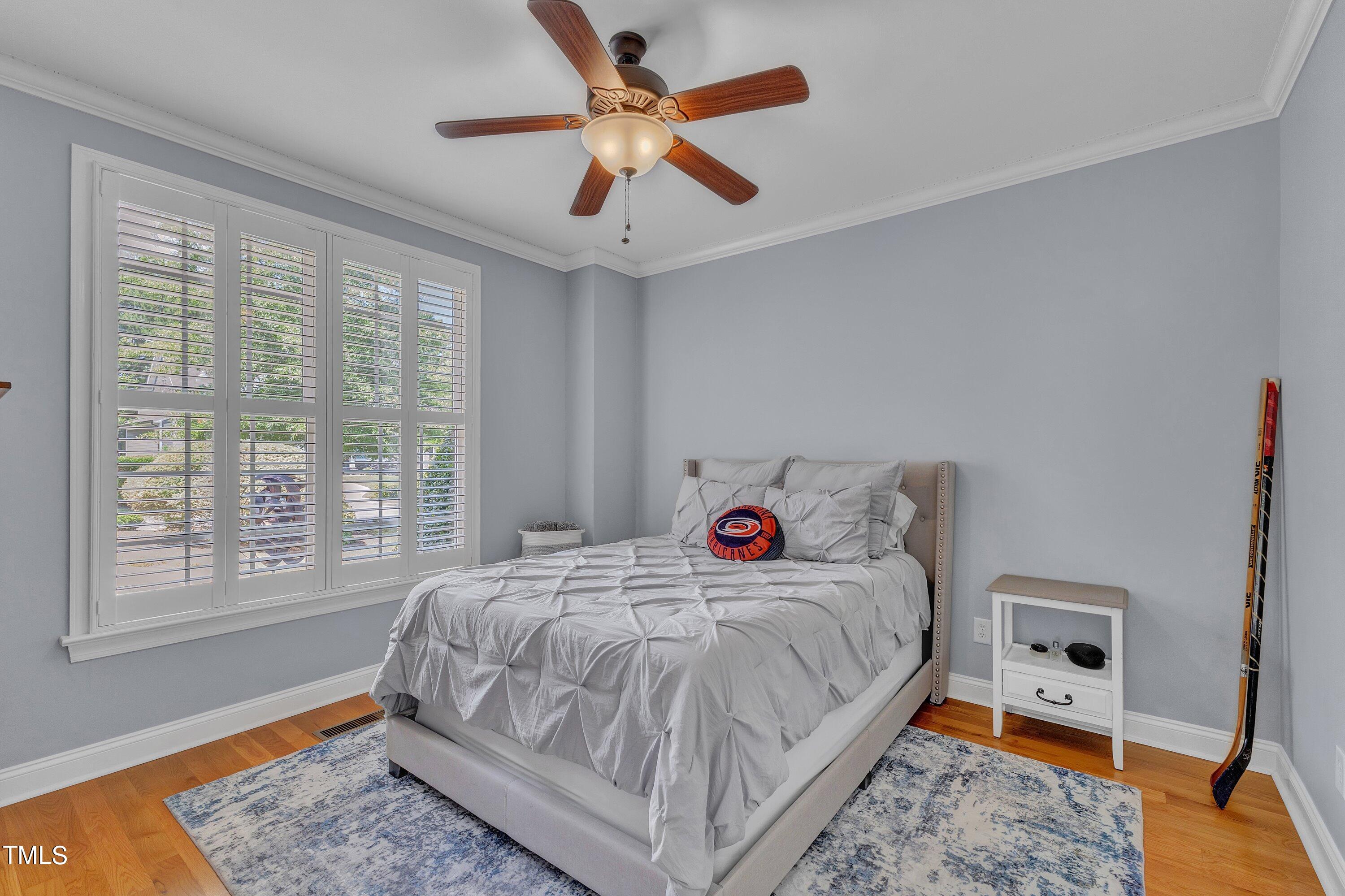 1741 Dunn Maple Drive Wake Forest, NC 27587 - Photo 25 of 63 a bedroom with a bed and a large window