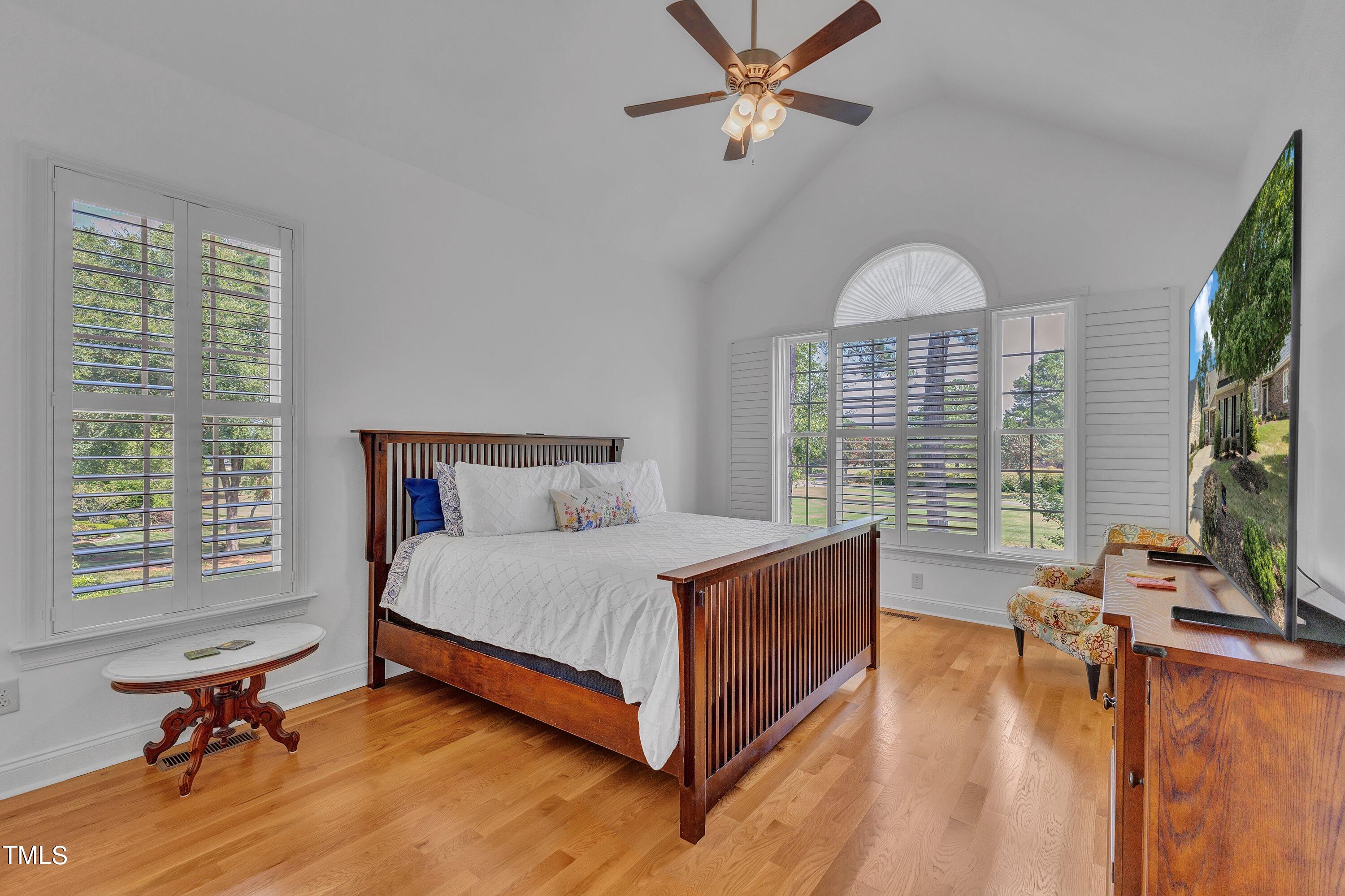 1741 Dunn Maple Drive Wake Forest, NC 27587 - Photo 26 of 63 a bed room with a bed and a chandelier