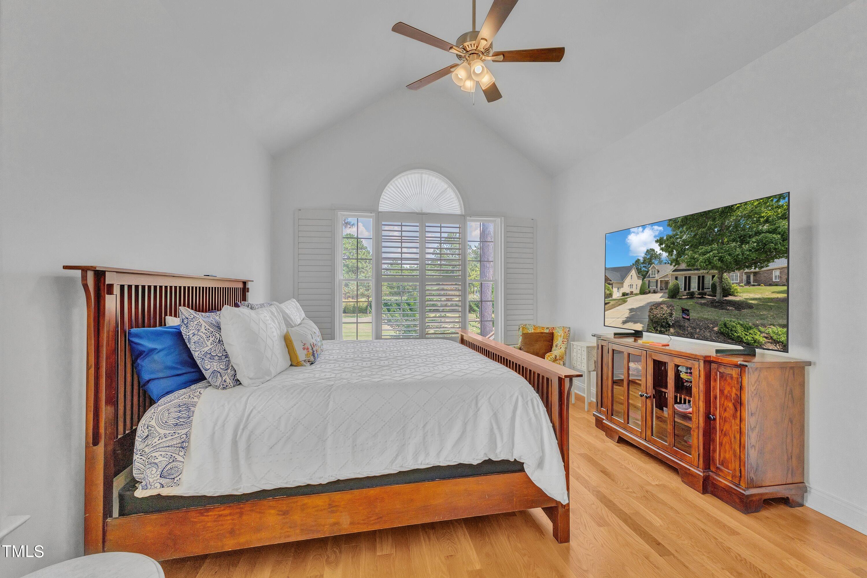 1741 Dunn Maple Drive Wake Forest, NC 27587 - Photo 29 of 63 a bedroom with a large bed and a chandelier