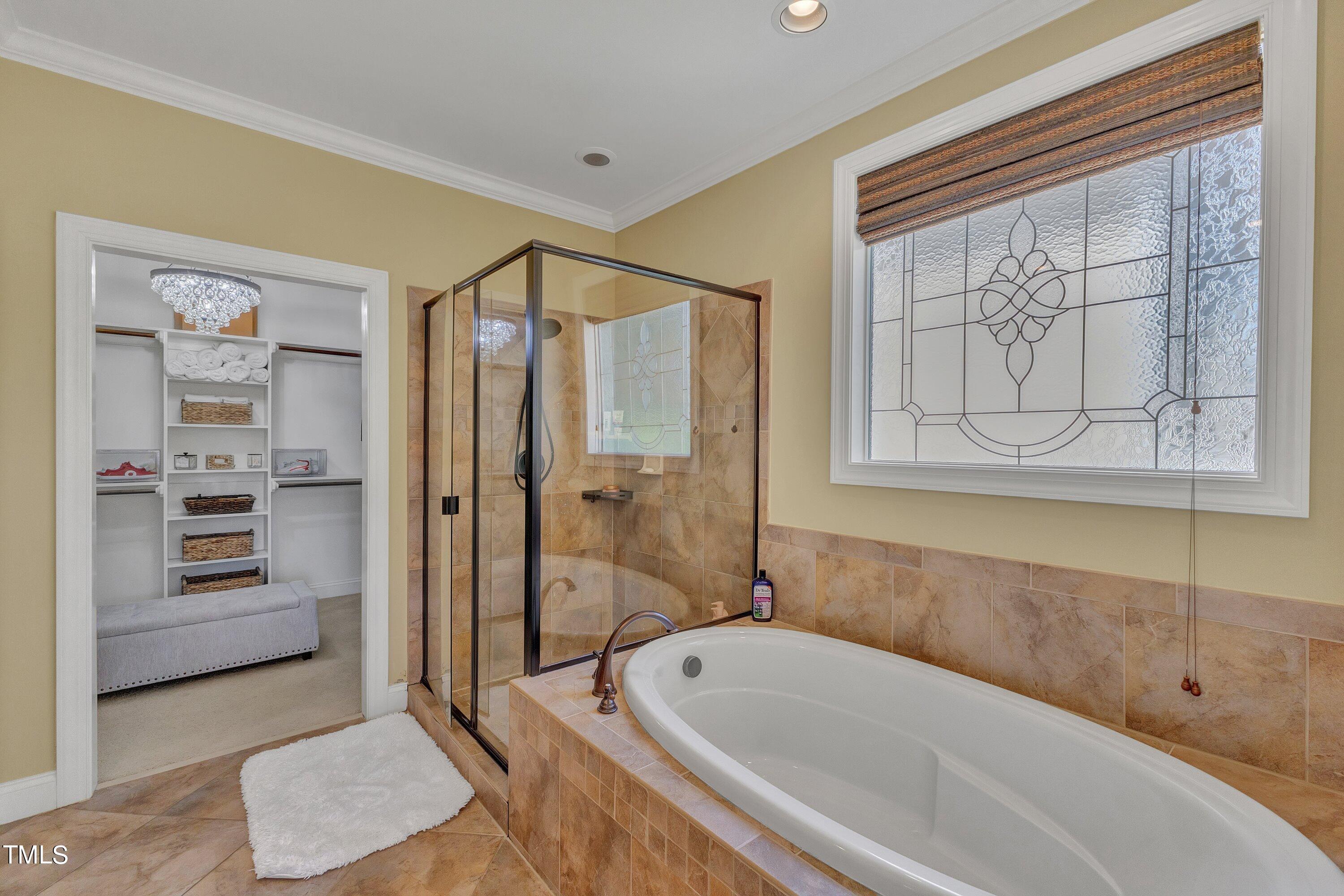 1741 Dunn Maple Drive Wake Forest, NC 27587 - Photo 31 of 63 a bathroom with a tub a sink and a shower