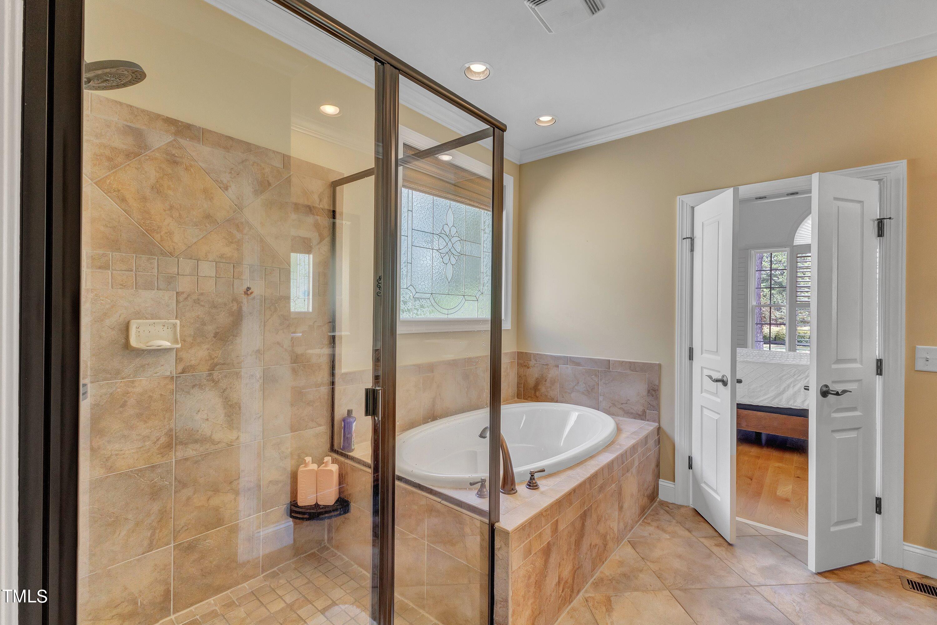 1741 Dunn Maple Drive Wake Forest, NC 27587 - Photo 33 of 63 a bathroom with a tub and shower