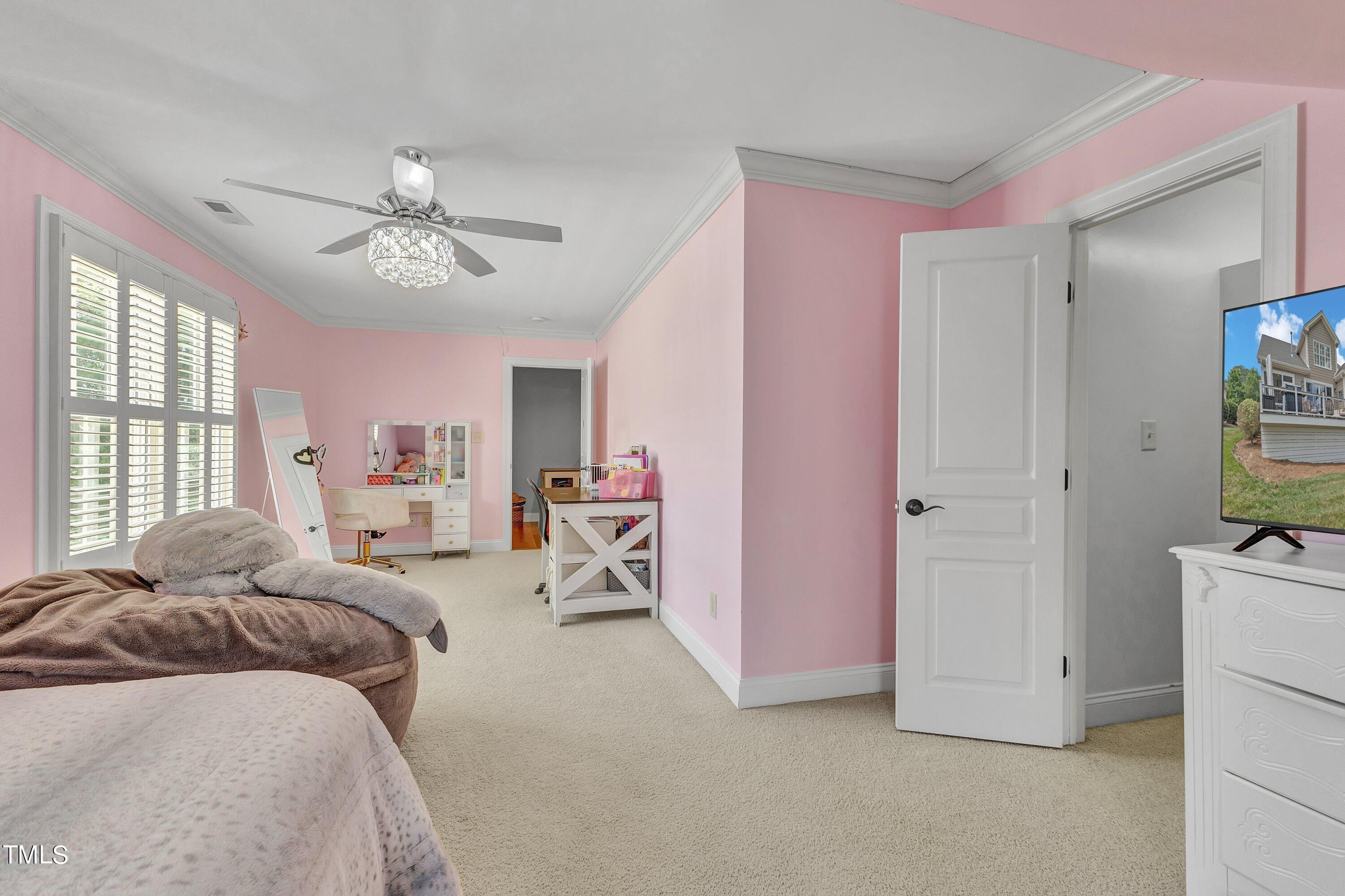 1741 Dunn Maple Drive Wake Forest, NC 27587 - Photo 36 of 63 a spacious bedroom with a bed and a chandelier