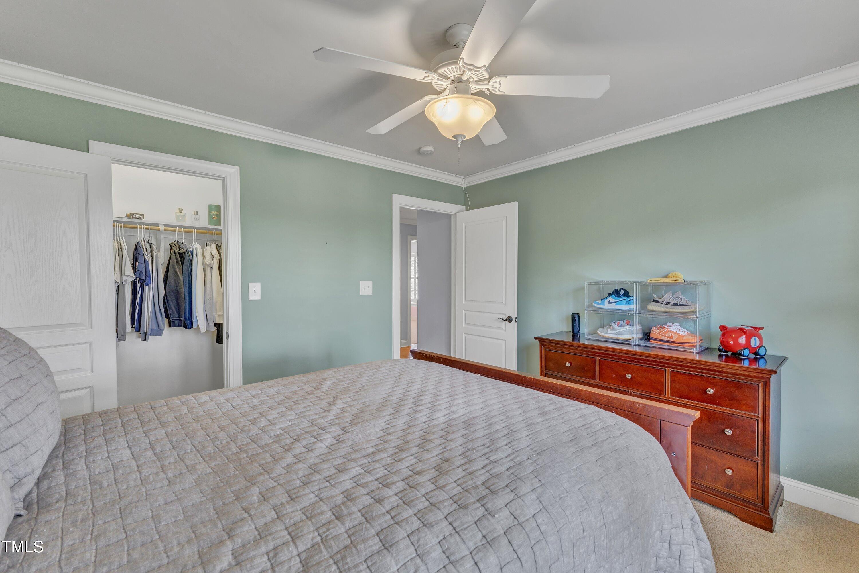 1741 Dunn Maple Drive Wake Forest, NC 27587 - Photo 39 of 63 a bedroom with a bed and a chandelier