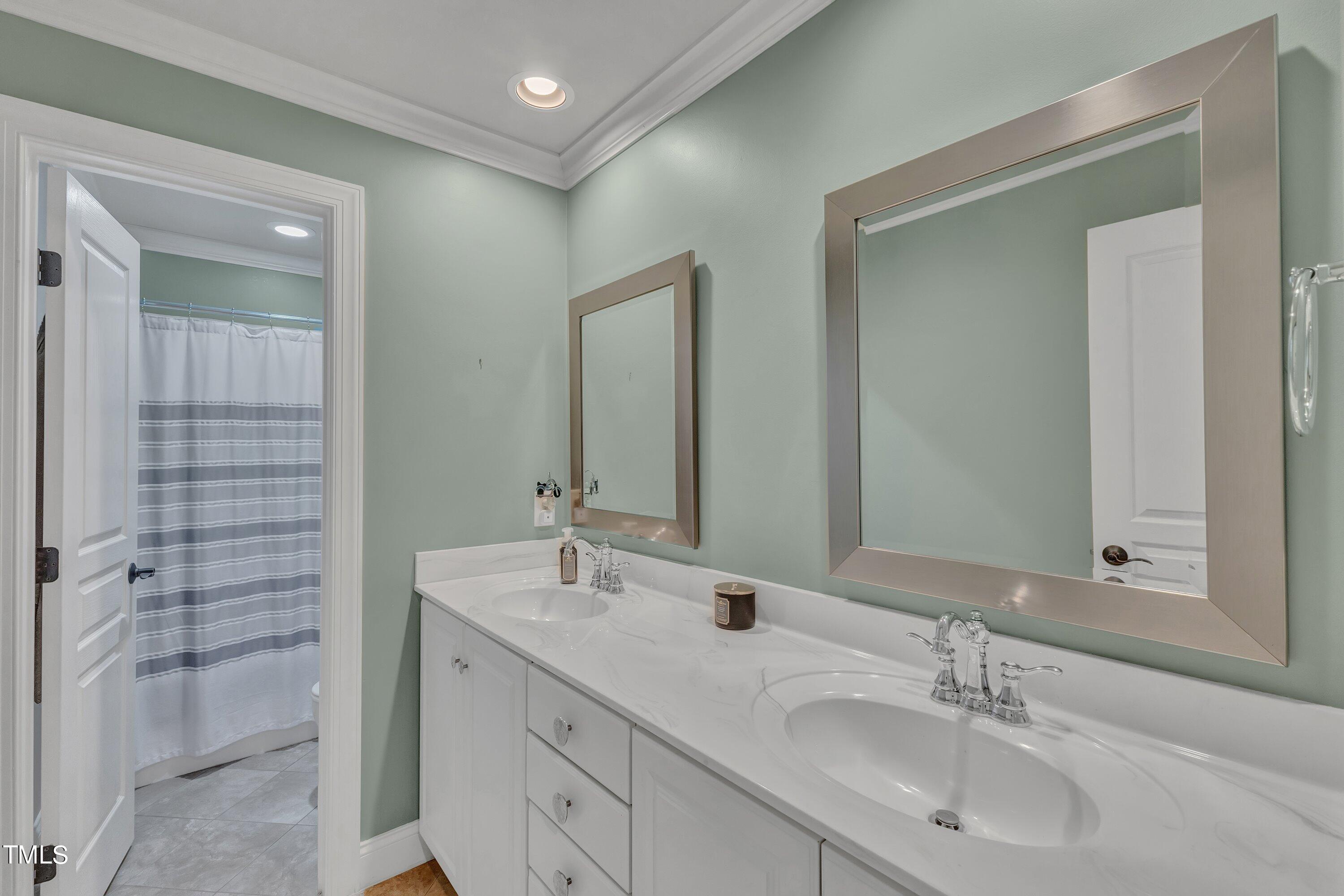 1741 Dunn Maple Drive Wake Forest, NC 27587 - Photo 40 of 63 a bathroom with a double vanity sink mirror and shower