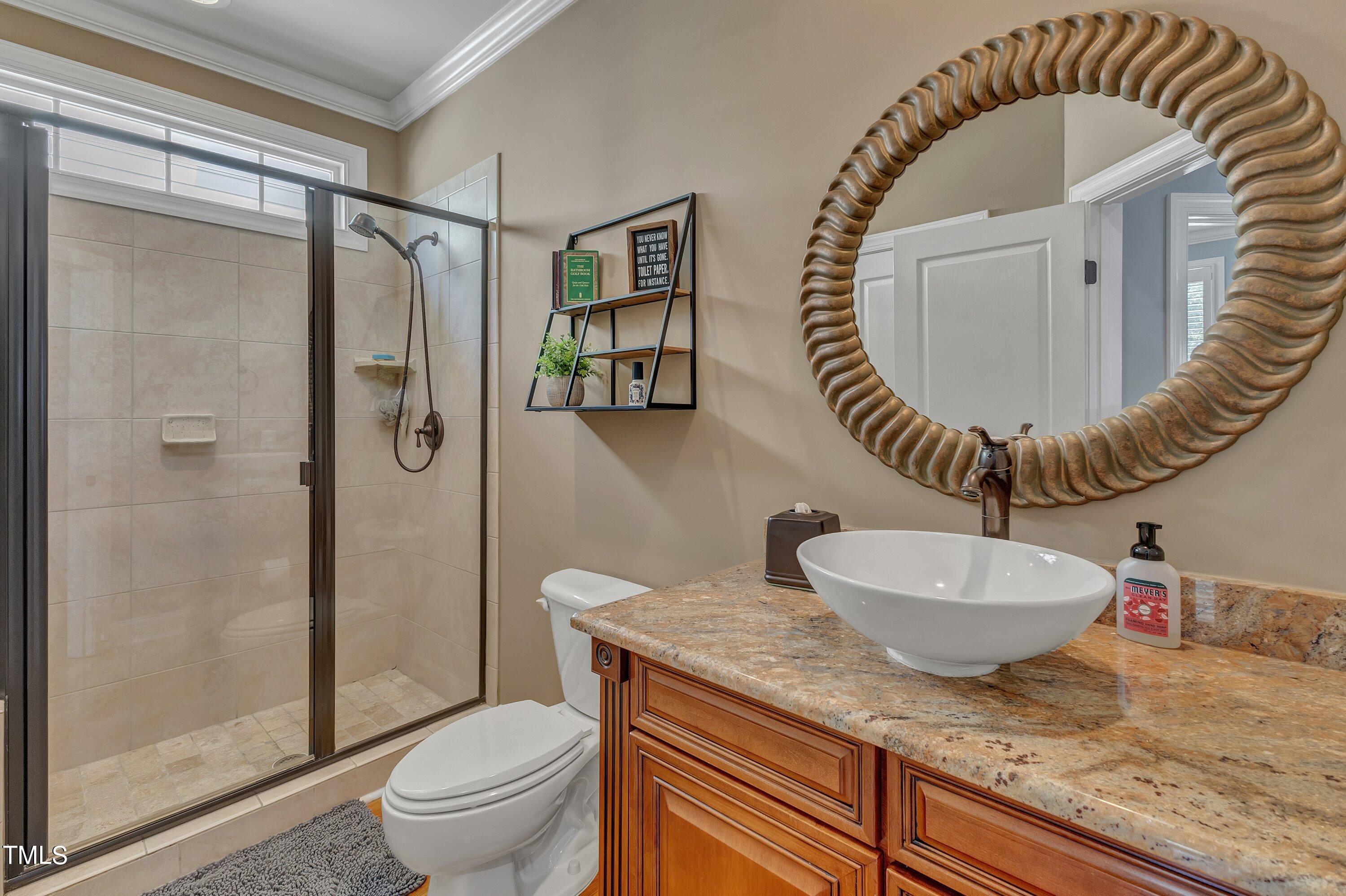 1741 Dunn Maple Drive Wake Forest, NC 27587 - Photo 6 of 63 a bathroom with a toilet a sink and mirror