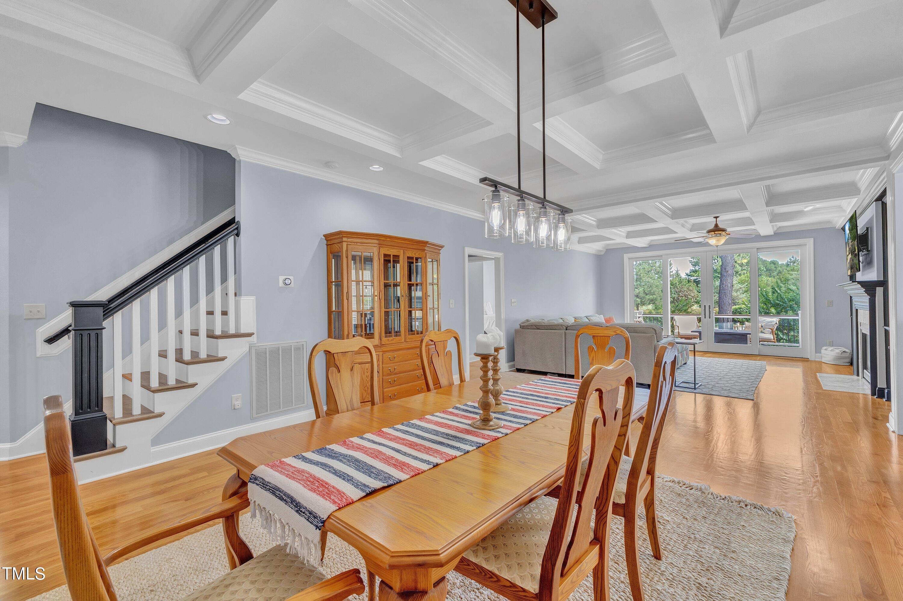 1741 Dunn Maple Drive Wake Forest, NC 27587 - Photo 8 of 63 a dining room with furniture a chandelier and wooden floor