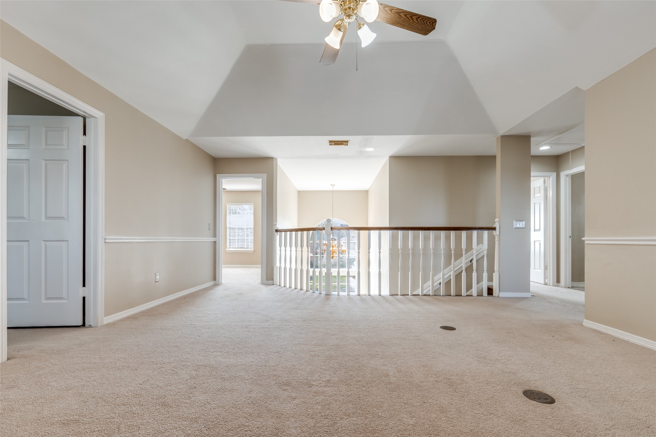 19026 Owen Oak Drive Humble, TX 77346 - Photo 12 of 25 an empty room with chandelier fan and windows