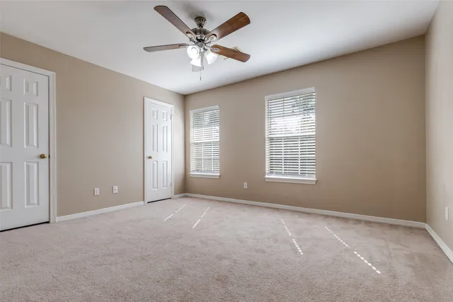 an empty room with wooden floor and closet area