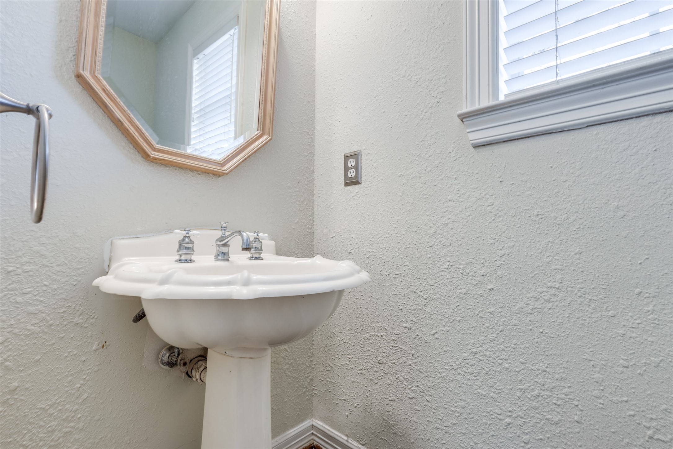19026 Owen Oak Drive Humble, TX 77346 - Photo 16 of 25 a bathroom with a sink a mirror and a window