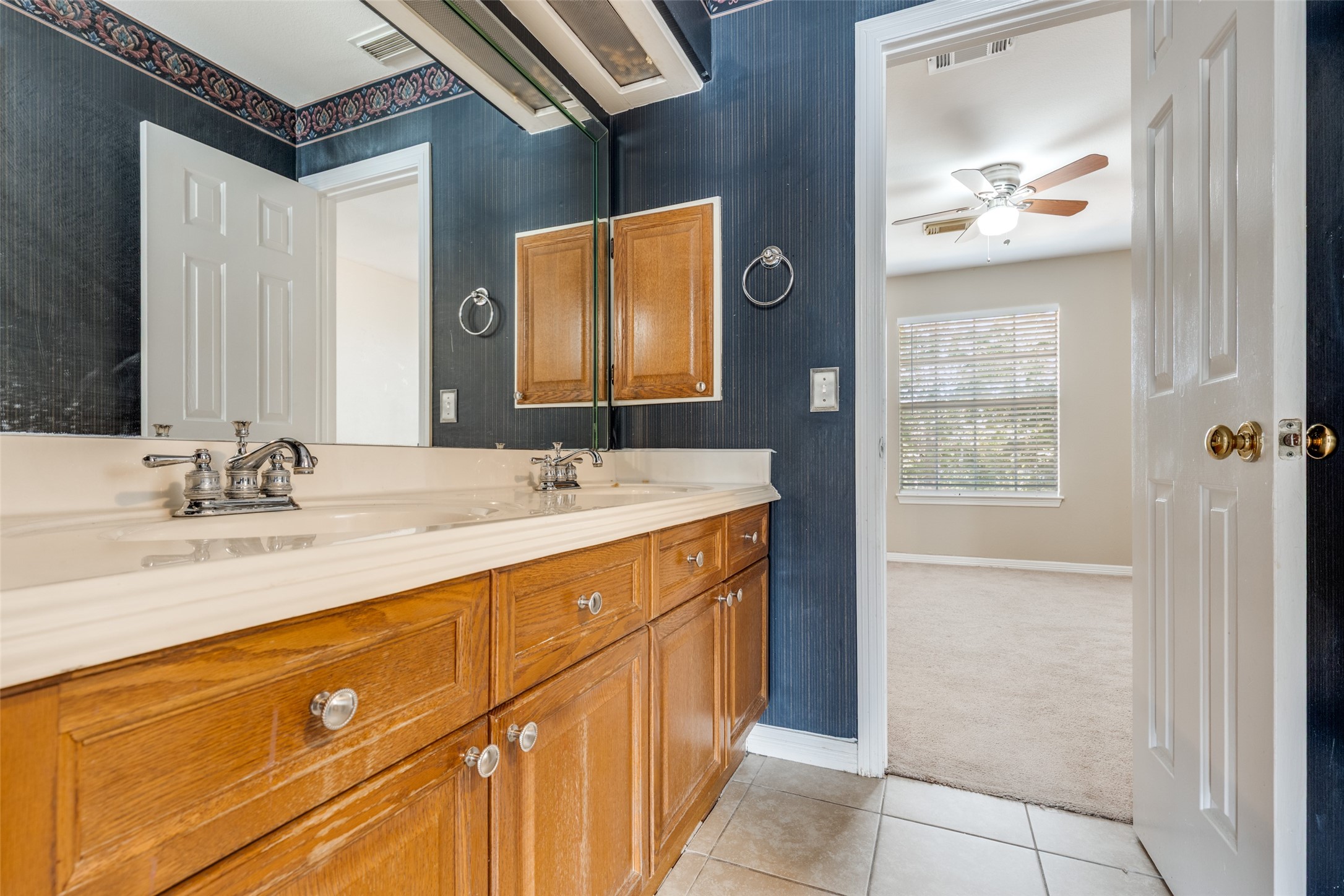 19026 Owen Oak Drive Humble, TX 77346 - Photo 20 of 25 a bathroom with a sink a vanity and a mirror