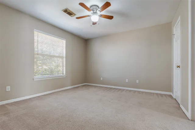a room with window and ceiling fan