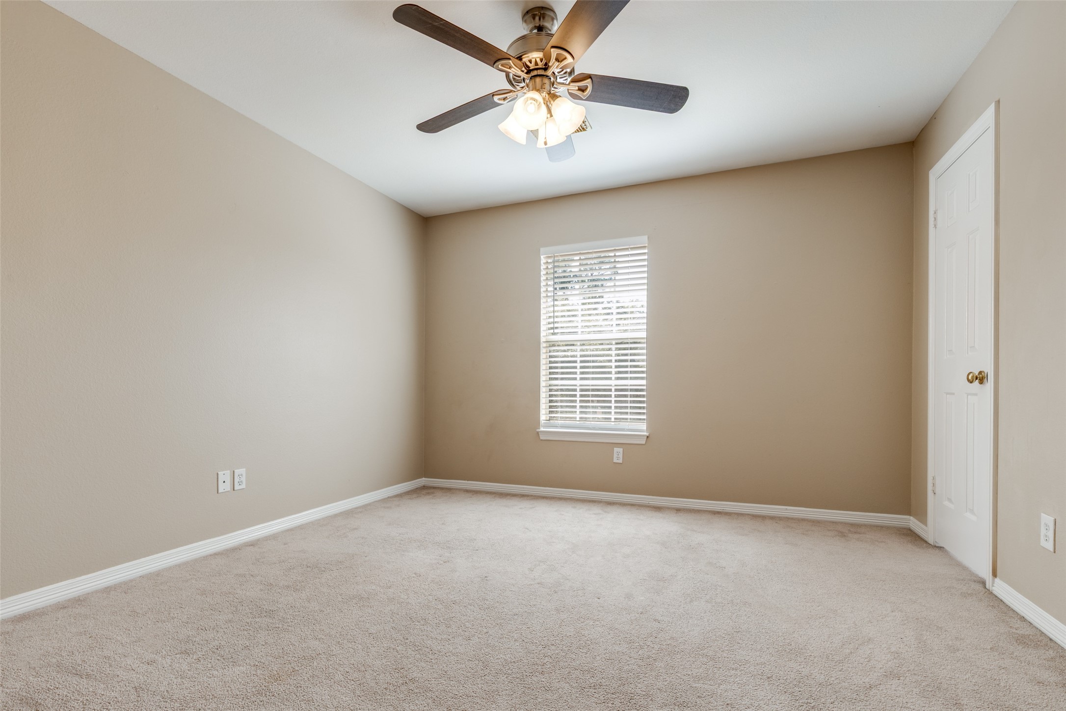 19026 Owen Oak Drive Humble, TX 77346 - Photo 23 of 25 an empty room with a window and a fan