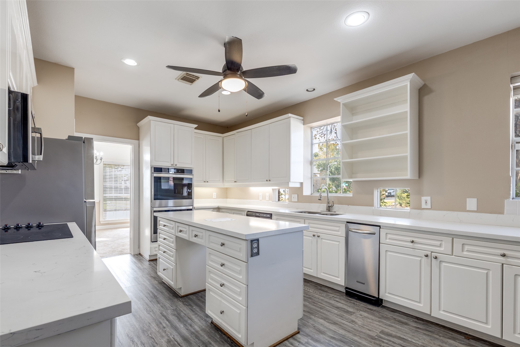 19026 Owen Oak Drive Humble, TX 77346 - Photo 9 of 25 a kitchen with a sink stainless steel appliances and cabinets