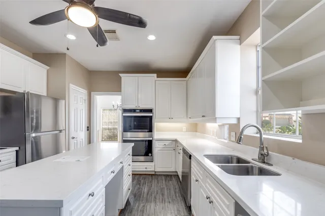 a kitchen with a sink stove and refrigerator