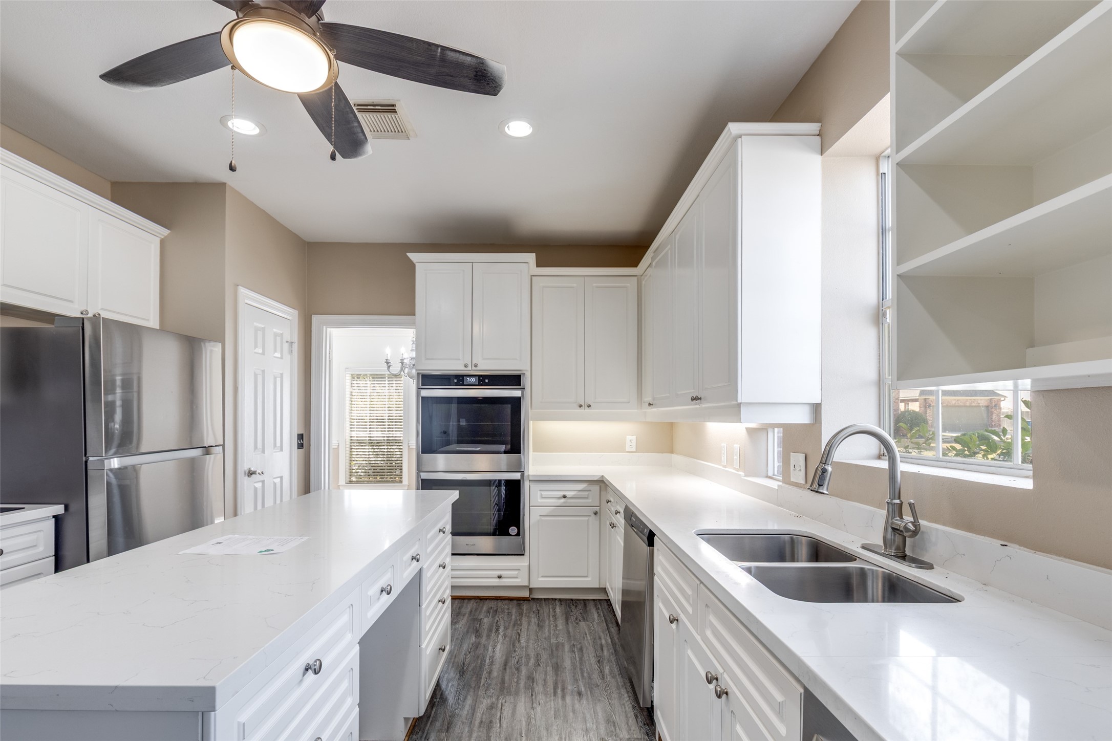 19026 Owen Oak Drive Humble, TX 77346 - Photo 10 of 25 a kitchen with kitchen island granite countertop a sink stainless steel appliances and counter space