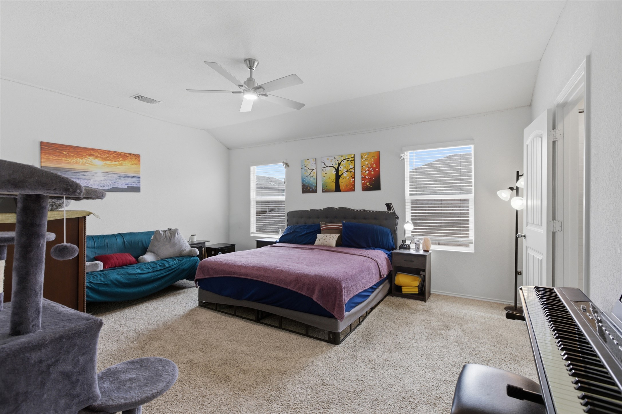 19017 Romano Drive Elgin, TX 78621 - Photo 24 of 33 Spacious room featuring vaulted ceilings, carpet flooring, a ceiling fan, and multiple windows with blinds
