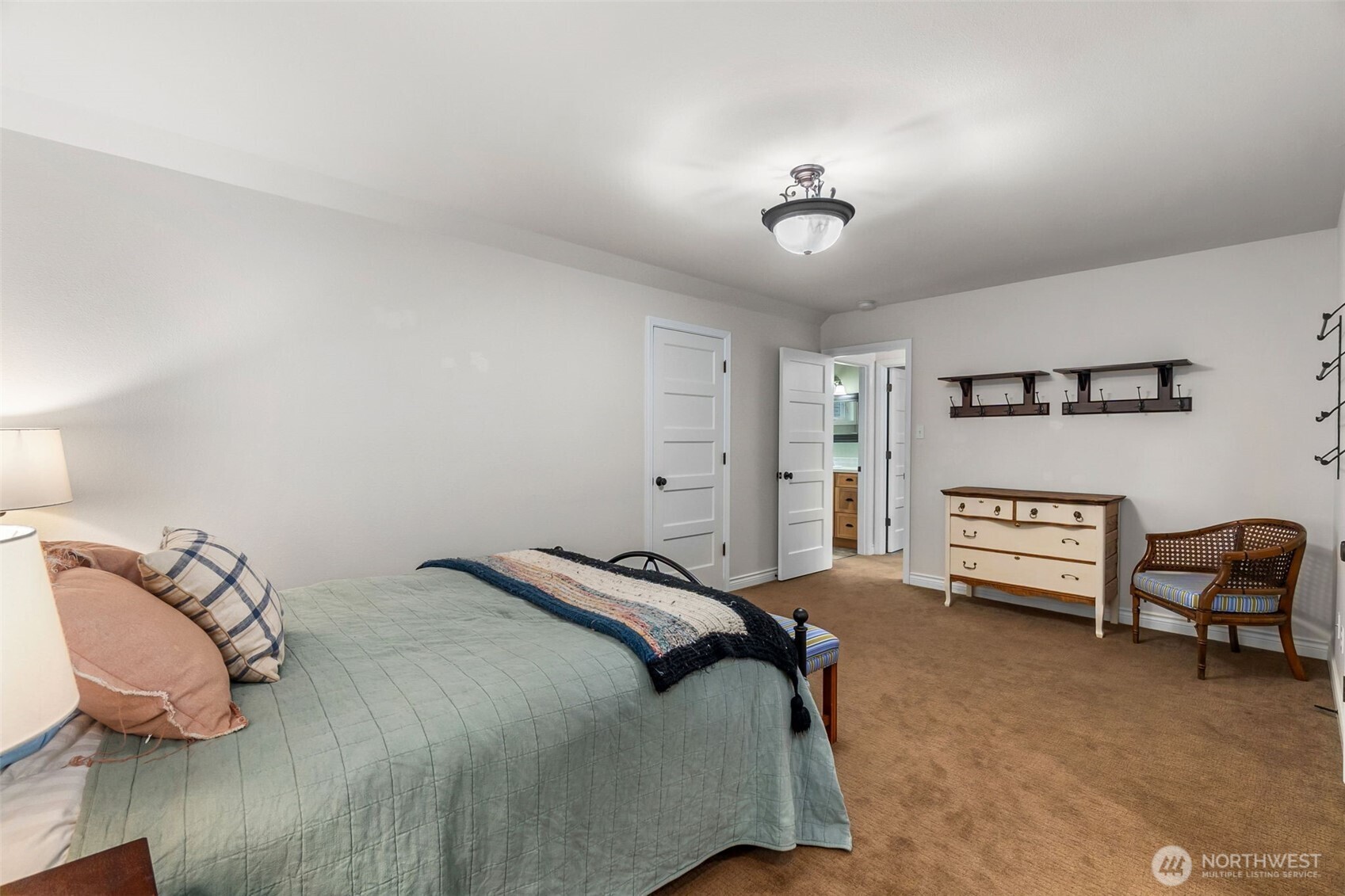 1130 East Sunset Hill Road Shelton, WA 98584 - Photo 32 of 40 a bedroom with a bed and a chandelier