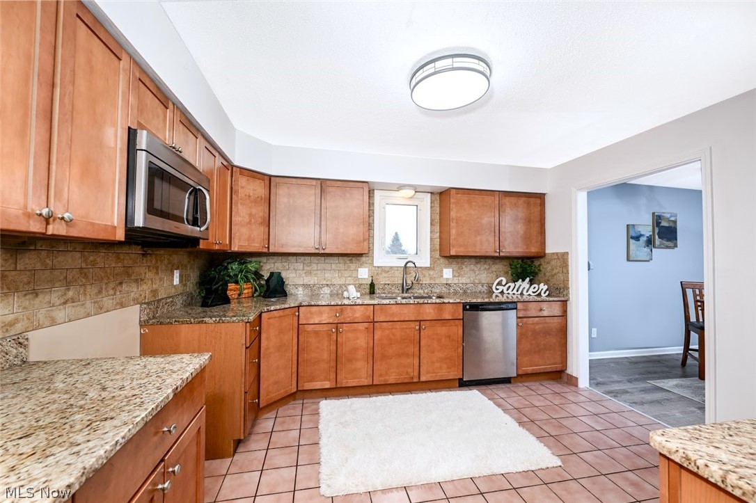 6151 Taylor Road Clinton, OH 44216 - Photo 17 of 49 *NICE KITCHEN W/GRANITE COUNTERTOPS, TILE BACKSPLASH, MAPLE CABINETS WITH SOFT CLOSE DRAWERS, SIDE PANTRY AREA, STAINLESS FAUCET ~