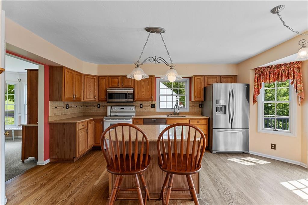16 McBride Road Canonsburg, PA 15317 - Photo 17 of 43 Open and inviting eat-in kitchen with granite countertops island, solid oak cabinets, pantry, and French doors to the Trex deck
