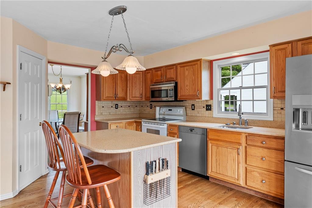 16 McBride Road Canonsburg, PA 15317 - Photo 18 of 43 Open and inviting eat-in kitchen with granite countertops island, solid oak cabinets, pantry, and French doors to the Trex deck