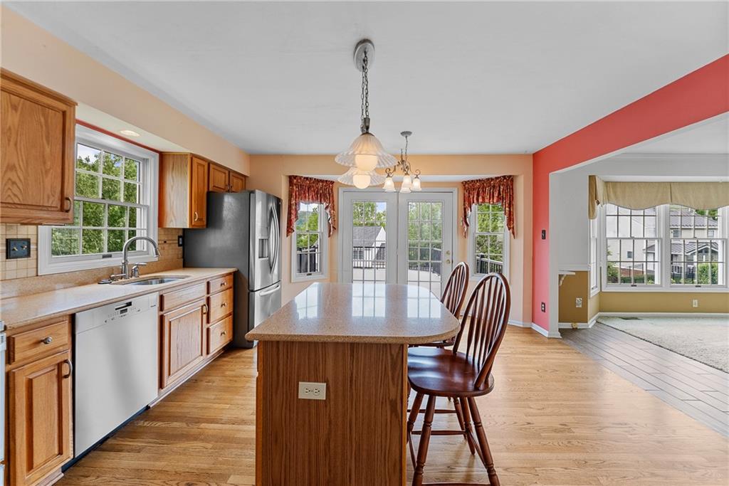 16 McBride Road Canonsburg, PA 15317 - Photo 20 of 43 Open and inviting eat-in kitchen with granite countertops island, solid oak cabinets, pantry, and French doors to the Trex deck