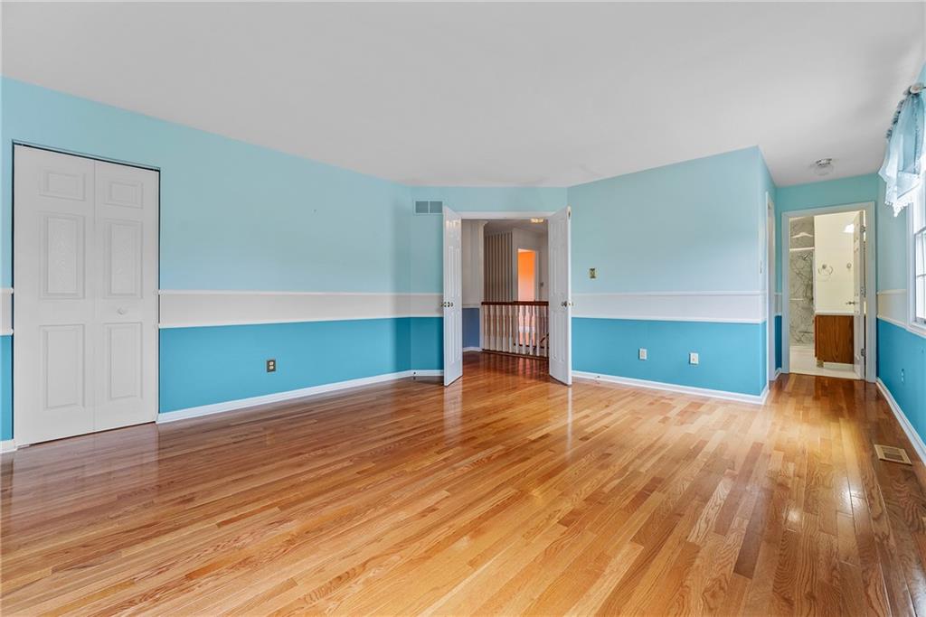 16 McBride Road Canonsburg, PA 15317 - Photo 24 of 43 Primary bedroom with hardwood flooring and newly renovated private bathroom