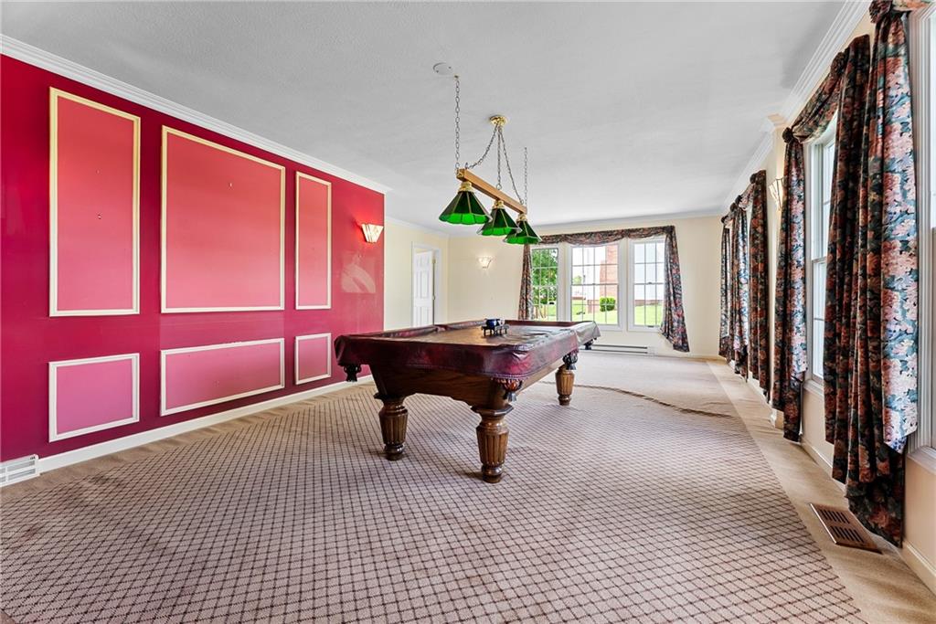 Spacious 24x17 main-level game room—pool table and chairs included! This versatile space offers endless possibilities for fun and relaxation. Whether you add a dartboard, shuffleboard, or your own creative touch, it’s the perfect spot for entertaining. No basement? No problem—this custom game room takes its place beautifully