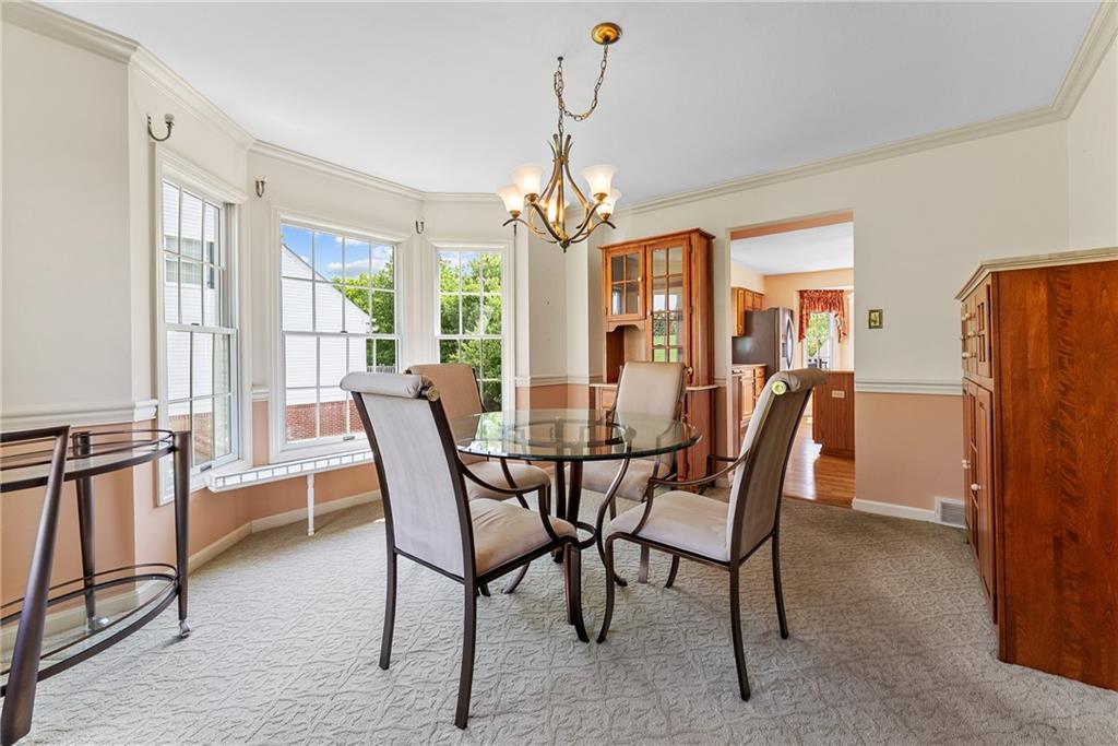 16 McBride Road Canonsburg, PA 15317 - Photo 10 of 43 Formal dining room with bay window, crown molding, and chair rail detailing