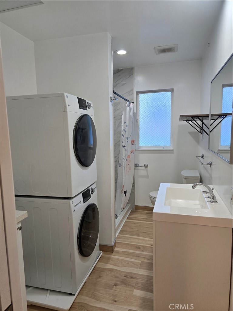 a utility room with sink dryer and washer