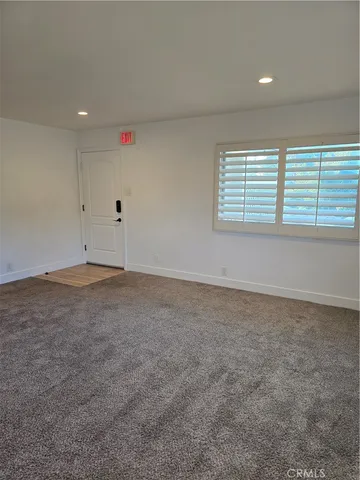 an empty room with a empty space and windows