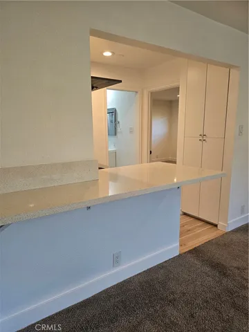 an empty room with wooden floor and mirror