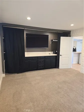 a view of an empty room with a kitchen