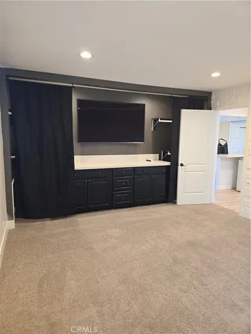 a view of an empty room with a kitchen