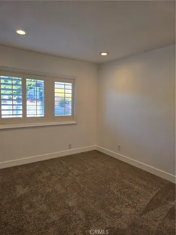 an empty room with a empty space and windows