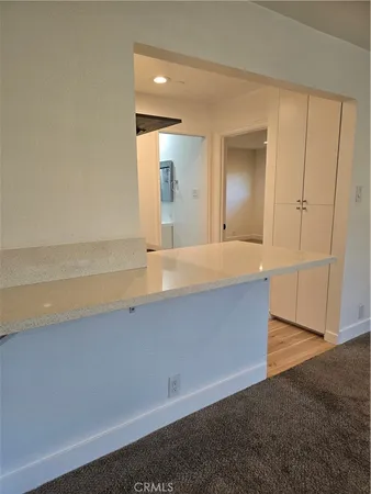 an empty room with wooden floor and mirror