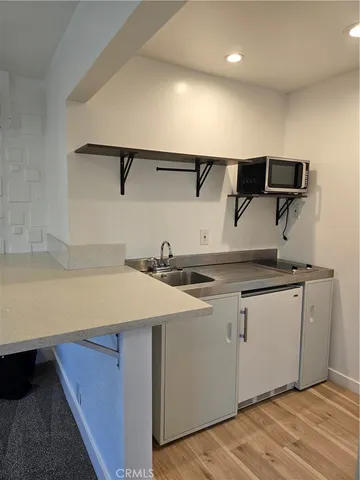 a kitchen with a sink and cabinets